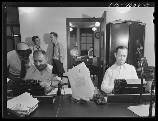 New York, New York. Telegraph room of the New York Times newspaper. News comes in from all over the country and abroad. Direct wire from Washington, D.C. Copy boys chatting in middle ground. In background is wire room with Associated Press and United Press wires