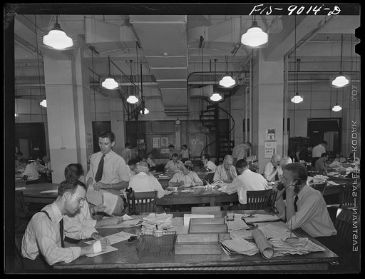 New York, New York. News room of the New York Times newspaper. Right foreground, city editor. Two assistants, left foreground. City copy desk in middle ground, with foreign desk, to right; telegraph desk to left. Make-up desk in center back with spiral staircase leading to composing room. Copy reade