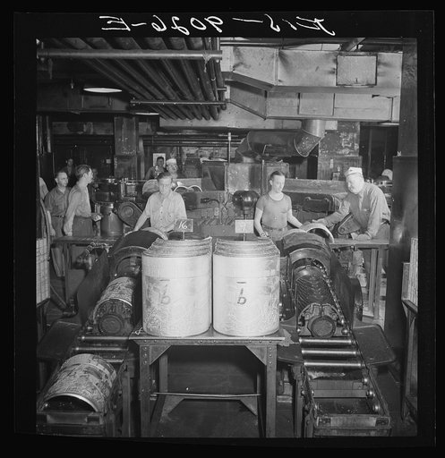 New York, New York. Pressroom of the New York Times newspaper. After casting, plates are shaved of unessential metal, and cooled in water in shaver