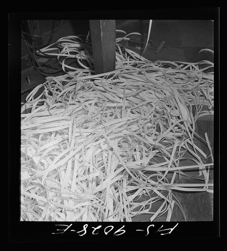 New York, New York. Radio room of the New York Times newspaper. Tape on which messages have been recorded in international Morse code piles up on floor