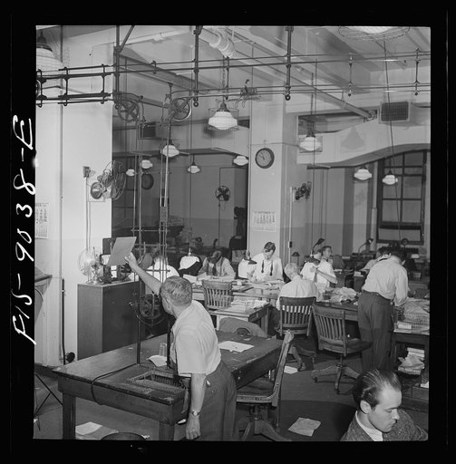 New York, New York. Newsroom of the New York Times newspaper. Ten o'clock is news room deadline. Copy is sent up to composing room on moving belt. Telegraph desk in background