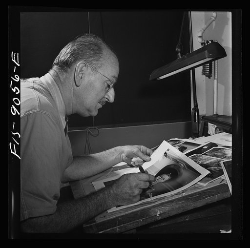 New York, New York. Art department of the New York Times newspaper. Photo retoucher touching up a fashion photograph for Sunday paper