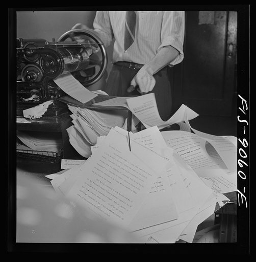 New York, New York. Wire room of the New York Times newspaper. Copy boys mimeograph all incoming dispatches which are then passed through slot into newsroom
