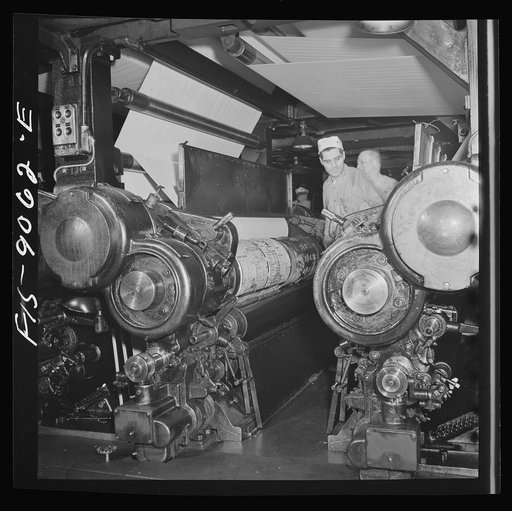 New York, New York. Pressroom of the New York Times newspaper. Putting plates into presses before they start rolling