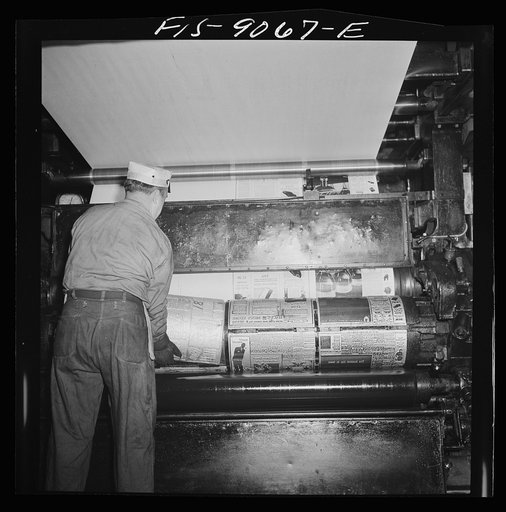New York, New York. Pressroom of the New York Times newspaper. Placing plates on cylinder of press