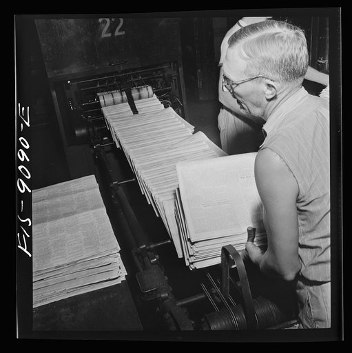 New York, New York. Mailroom of the New York Times newspaper. Papers come from the pressroom on a conveyor