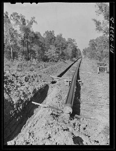 Untitled photo, possibly related to: Arkansas-Texas state line to Gurdon, Arkansas War emergency pipeline from Longview, Texas to Norris City, Illinois. A trench-digging machine