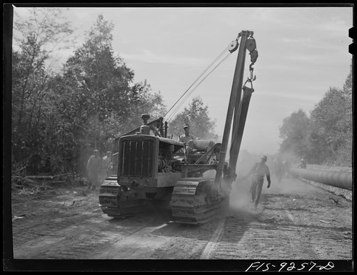 Untitled photo, possibly related to: Little Rock, Arkansas to Missouri-Arkansas state line. War emergency pipeline from Longview, Texas to Norris City, Illinois. Caterpillar tractor with crane for lifting pipe