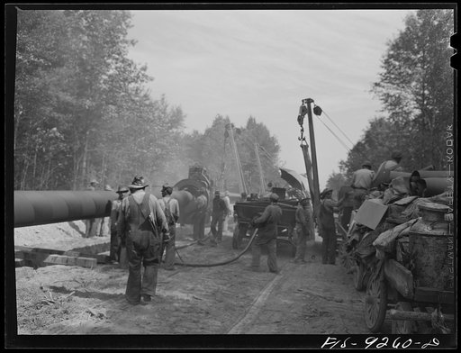 Untitled photo, possibly related to: Little Rock, Arkansas to Missouri-Arkansas state line. War emergency pipeline from Longview, Texas to Norris City, Illinois. Each forty-foot section is welded onto the main line in the stove pipe method of welding line