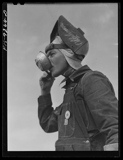 Little Rock, Arkansas to Missouri-Arkansas state line. War emergency pipeline from Longview, Texas to Norris City, Illinois. Welder getting a drink of water
