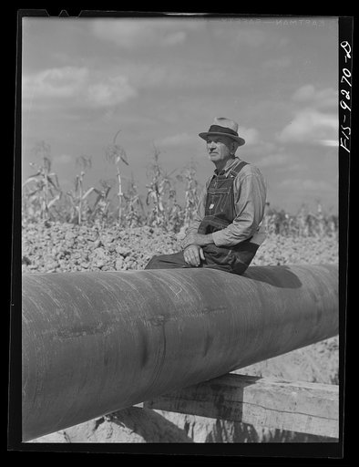 Untitled photo, possibly related to: Little Rock, Arkansas to Missouri-Arkansas state line. War emergency pipeline from Longview, Texas to Norris City, Illinois. A local farmer watching progress of the pipeline construction