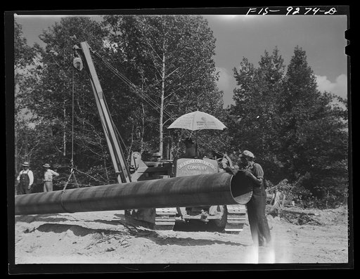 Untitled photo, possibly related to: Little Rock, Arkansas to Missouri-Arkansas state line. War emergency pipeline from Longview, Texas to Norris City, Illinois. Each forty-foot section is welded onto the main line in the stove pipe method of welding line