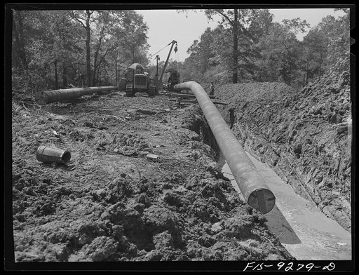 Little Rock, Arkansas to Missouri-Arkansas state line. War emergency pipeline from Longview, Texas to Norris City, Illinois. Pipeline approaching canal. Wooden plug in end of pipe will keep dirt and animals out