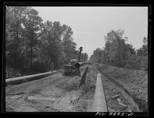 Little Rock, Arkansas to Missouri-Arkansas state line. War emergency pipeline from Longview, Texas to Norris City, Illinois. Bringing a forty-foot section to main line in stove pipe method of welding