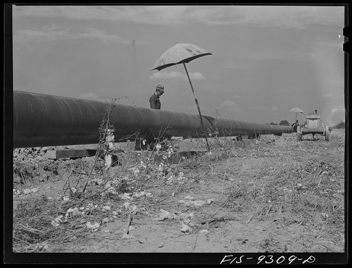 Little Rock, Arkansas to Missouri-Arkansas state line. War emergency pipeline from Longview, Texas to Norris City, Illinois. Pipeline cutting through cotton field