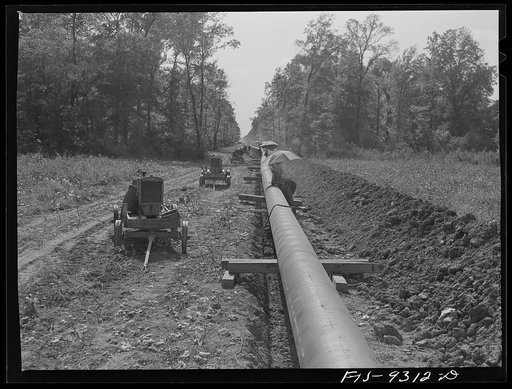 Arkansas-Texas state line to Gurdon, Arkansas. War emergency pipeline from Longview, Texas to Norris City, Illinois. Firing line of welders at work on the pipeline
