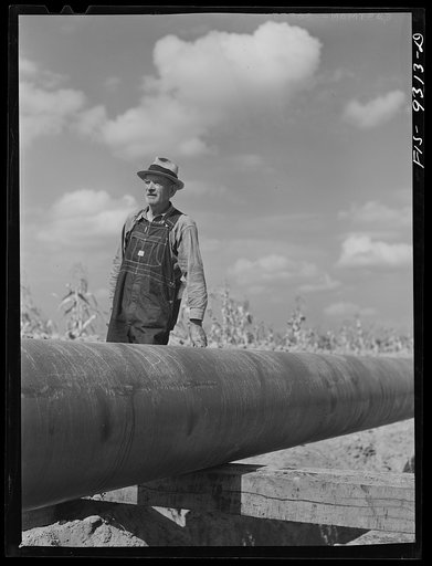 Little Rock, Arkansas to Missouri-Arkansas state line. War emergency pipeline from Longview, Texas to Norris City, Illinois. A local farmer watching progress of the pipeline construction