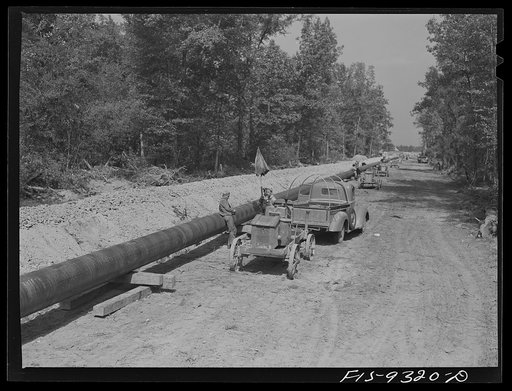 Arkansas-Texas state line to Gurdon, Arkansas. War emergency pipeline from Longview, Texas to Norris City, Illinois. Firing line of welders at work on the pipeline. Electricity is furnished by gasoline driven generators