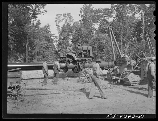 Little Rock, Arkansas to Missouri-Arkansas state line. War emergency pipeline from Longview, Texas to Norris City, Illinois. Priming machine rides along pipe suspended by cranes from two caterpillars