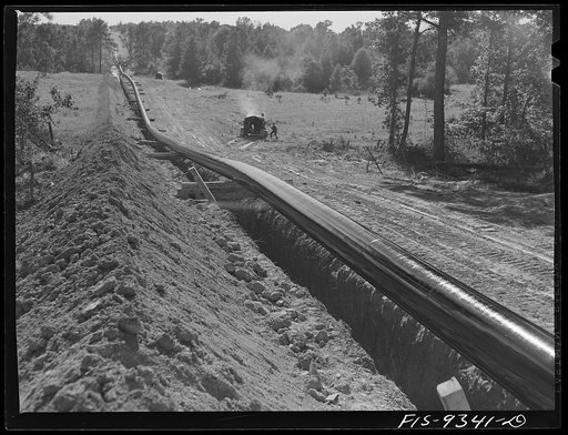 Longview, Texas to Arkansas state line. War emergency pipeline from Longview, Texas to Norris City, Illinois. Pipe primed but not yet wrapped. Notice slack to allow for contraction when oil starts flowing through