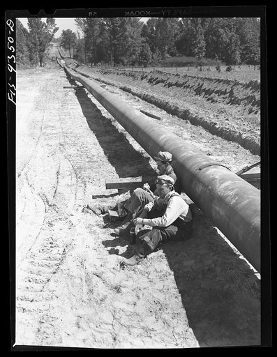Untitled photo, possibly related to: Longview, Texas to Arkansas state line. War emergency pipeline from Longview, Texas to Norris City, Illinois. Pipeliners at lunch