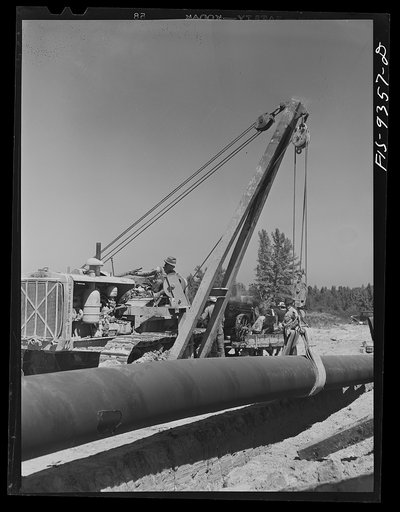 Untitled photo, possibly related to: Arkansas-Texas state line to Gurdon, Arkansas. War emergency pipeline from Longview, Texas to Norris City, Illinois. Placing additional felt around piece of pipe which was found defectively wrapped by inspector