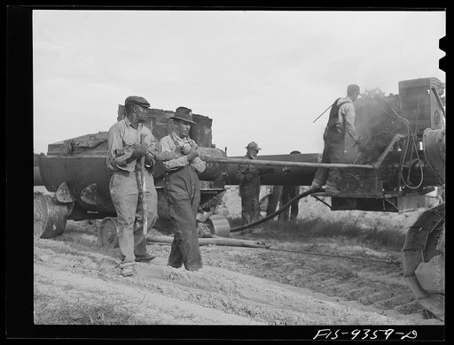 Untitled photo, possibly related to: Longview, Texas to Arkansas state line. War emergency pipeline from Longview, Texas to Norris City, Illinois. Doping crew wrapping pipe with felt