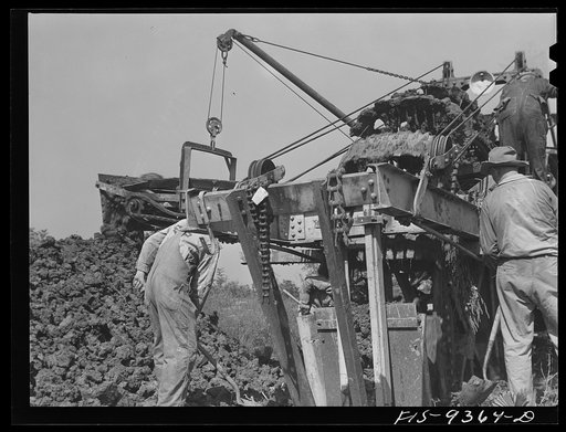 Untitled photo, possibly related to: Arkansas-Texas state line to Gurdon, Arkansas. War emergency pipeline from Longview, Texas to Norris City, Illinois. Pick and shovel workers following the ditching machine