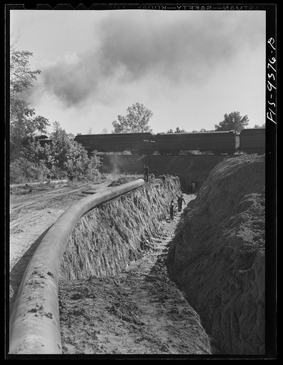 Untitled photo, possibly related to: Longview, Texas to Arkansas state line. War emergency pipeline from Longview, Texas to Norris, Illinois. The pipeline approaching a railroad crossing under which it will tunnel