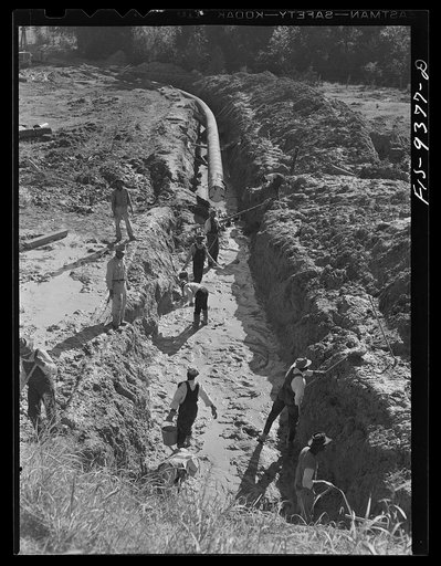 Longview, Texas to Arkansas state line. War emergency pipeline from Longview, Texas to Norris City, Illinois. Laborers removing mud and water from the drag hole