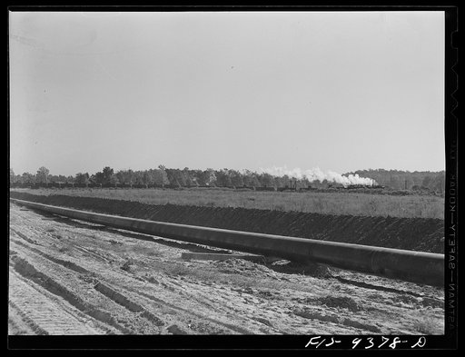 Longview, Texas to Arkansas state line. War emergency pipeline from Longview, Texas to Norris, Illinois. Train of oil tankcars crossing the pipeline