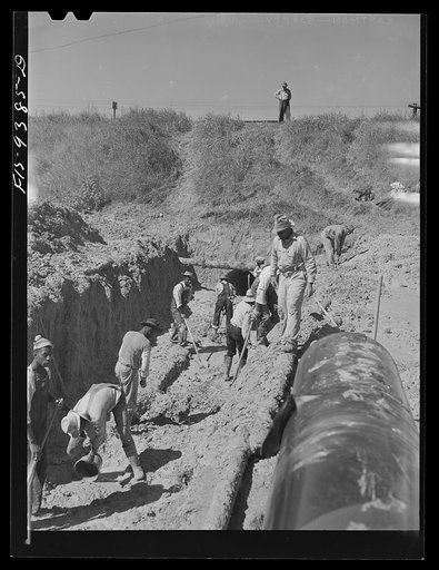 Untitled photo, possibly related to: Longview, Texas to Arkansas state line. War emergency pipeline from Longview, Texas to Norris City, Illinois. Digging a tunnel where pipeline will go under the railroad tracks