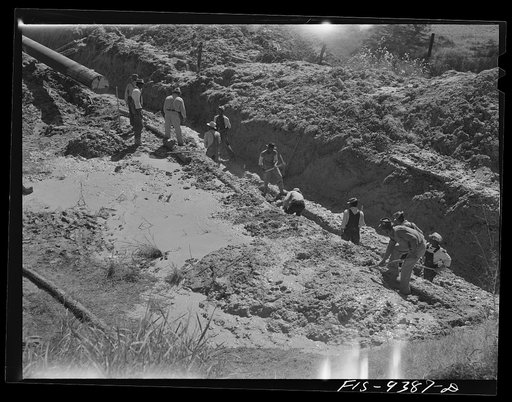 Longview, Texas to Arkansas state line. War emergency pipeline from Longview, Texas to Norris City, Illinois. Laborers removing mud and water from the drag hole