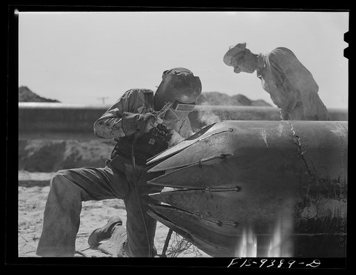 Untitled photo, possibly related to: Longview, Texas to Arkansas state line. War emergency pipeline from Longview, Texas to Norris City, Illinois. Making bull nose plug in casing for pipe going under railroad tracks