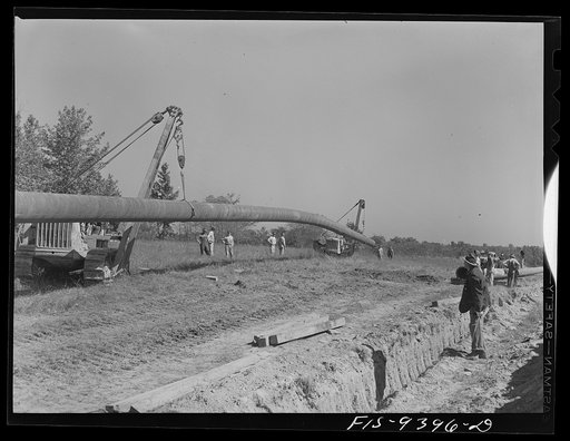Longview, Texas to Arkansas state line. War emergency pipeline from Longview, Texas to Norris City, Illinois. Moving 200 foot section of pipe welded to main line by firing line method