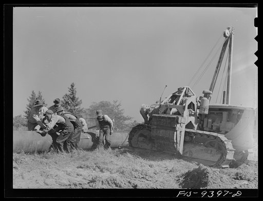 Untitled photo, possibly related to: Longview, Texas to Arkansas state line. War emergency pipeline from Longview, Texas to Norris City, Illinois. Moving 200 foot section of pipe welded to main line by firing line method