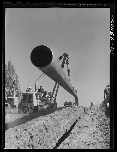 Longview, Texas to Arkansas state line. War emergency pipeline from Longview, Texas to Norris City, Illinois. Moving 200 foot section of pipe welded to main line by firing line method