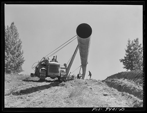 Longview, Texas to Arkansas state line. War emergency pipeline from Longview, Texas to Norris City, Illinois. Moving 200 foot section of pipe welded to main line by firing line method