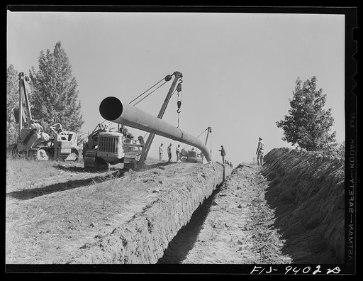 Longview, Texas to Arkansas state line. War emergency pipeline from Longview, Texas to Norris City, Illinois. Moving 200 foot section of pipe welded to main line by firing line method