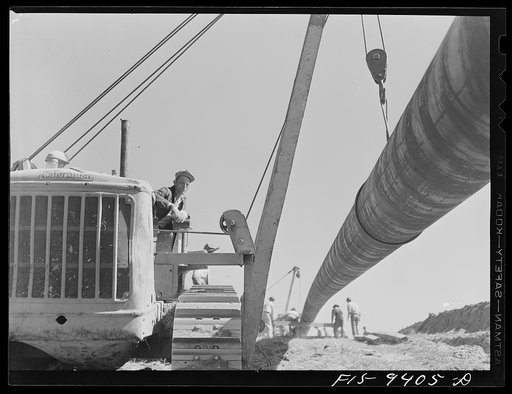 Longview, Texas to Arkansas state line. War emergency pipeline from Longview, Texas to Norris City, Illinois. Moving 200 foot section of pipe welded to main line by firing line method