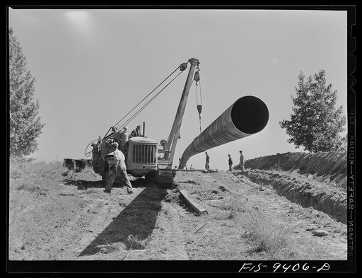 Untitled photo, possibly related to: Longview, Texas to Arkansas state line. War emergency pipeline from Longview, Texas to Norris City, Illinois. Moving 200 foot section of pipe welded to main line by firing line method