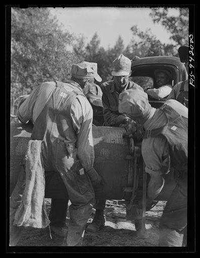Untitled photo, possibly related to: Little Rock, Arkansas to Missouri-Arkanasas state line. War emergency pipeline from Longview, Texas to Norris City, Illinois. Joining forty-foot section of pipe to line before welding