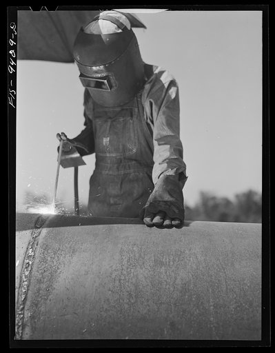 Untitled photo, possibly related to: Longview, Texas to Arkansas state line. War emergency pipeline from Longview, Texas to Norris City, Illinois. Electric welder