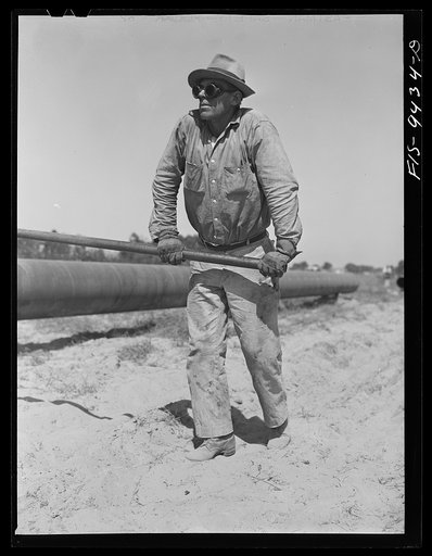 Longview, Texas to Arkansas state line. War emergency pipeline from Longview, Texas to Norris City, Illinois. Pipe roller rotating the pipe while welder works