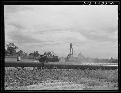 Untitled photo, possibly related to: Little Rock, Arkansas to Missouri-Arkansas state line. War emergency pipeline from Longview, Texas to Norris City, Illinois. Section of pipe ready to be joined to the main line by stove pipe methof of welding