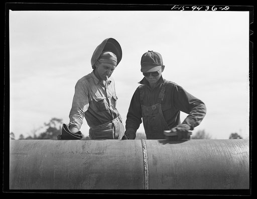 Longview, Texas to Arkansas state line. War emergency pipeline from Longview, Texas to Norris City, Illinois. Welder and assistant