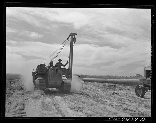 Little Rock, Arkansas to Missouri-Arkansas state line. War emergency pipeline from Longview, Texas to Norris City, Illinois. Caterpillar tractor and crane used in hoisting sections of pipe