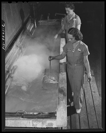 De Soto bomber plant. Detroit, Michigan. Girls dipping magnesium tubing in hot clean bath to get rid of grease and acid