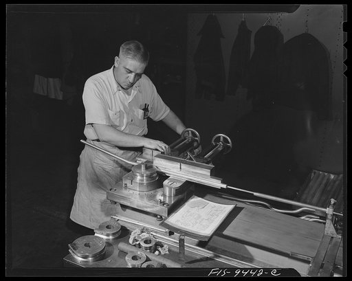 Untitled photo, possibly related to: De Soto bomber plant. Detroit, Michigan. Worker at bending machine producing complex curves. The wires for the airplanes are inserted through these magnesium tubes