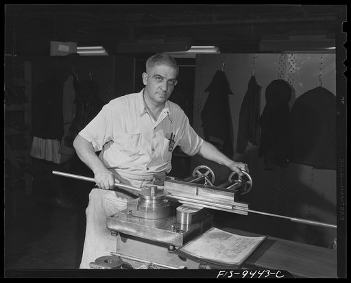 De Soto bomber plant. Detroit, Michigan. Worker at bending machine producing complex curves. The wires for the airplanes are inserted through these magnesium tubes